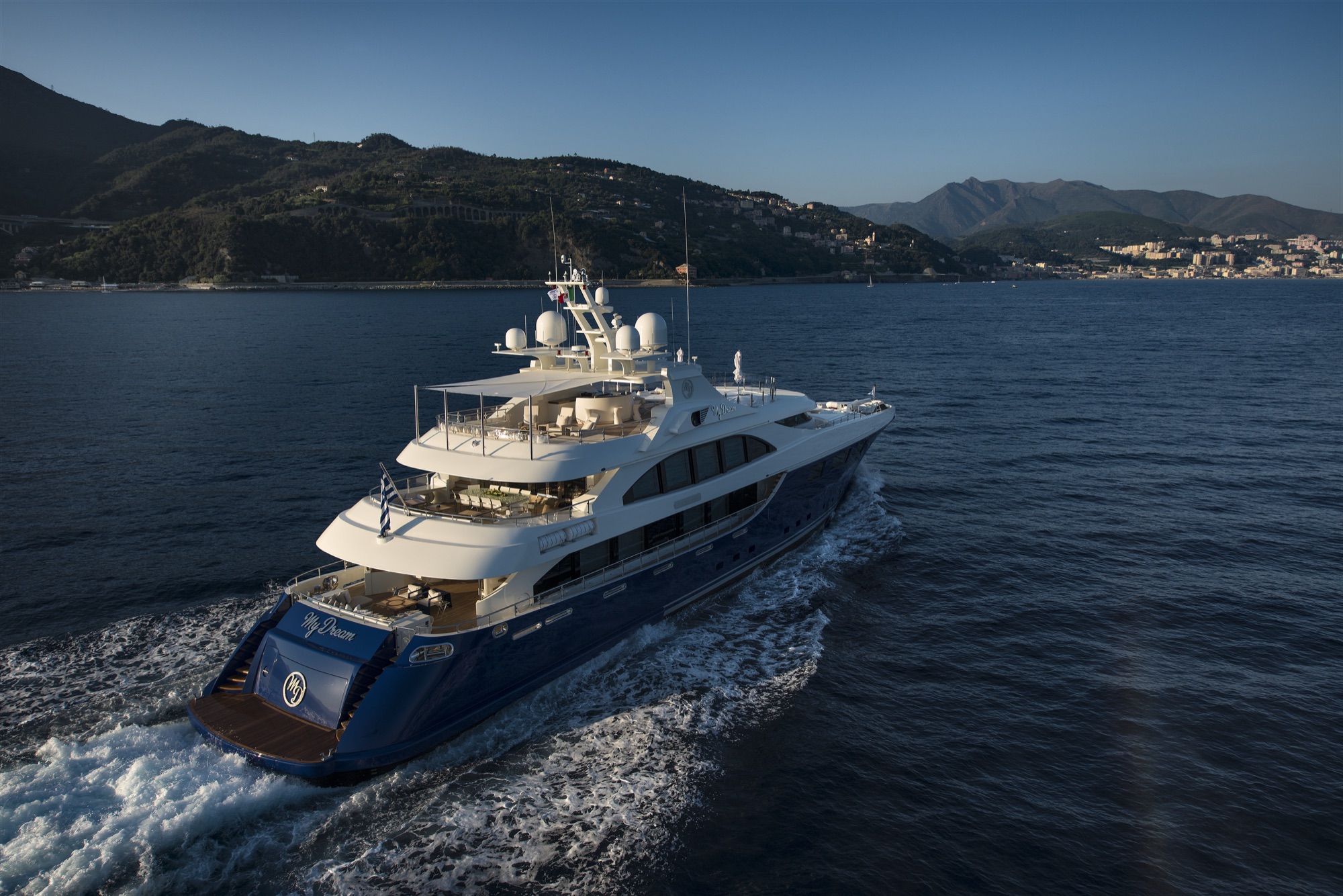 Aerial view of M/Y My Dream running along the Ligurian coast in late light