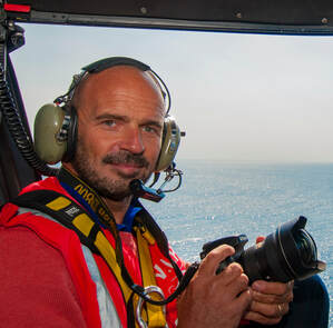 Martino Motti on helicopter as yacht photographer